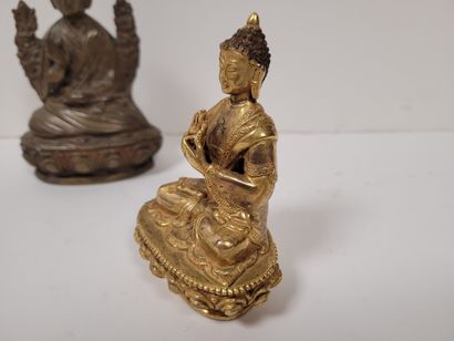 null Two bronze statuettes, Asia, 20th
centuryOne gilded representing Buddha, hands...