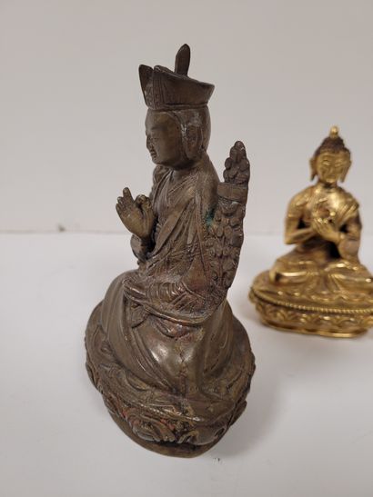 null Two bronze statuettes, Asia, 20th
centuryOne gilded representing Buddha, hands...