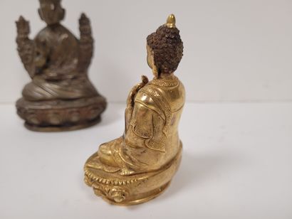 null Two bronze statuettes, Asia, 20th
centuryOne gilded representing Buddha, hands...