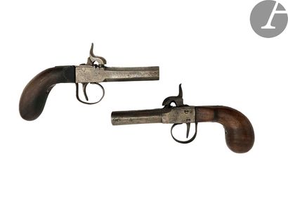 null Two percussion cap pistols.
The first with round barrel, iron trigger guard,...