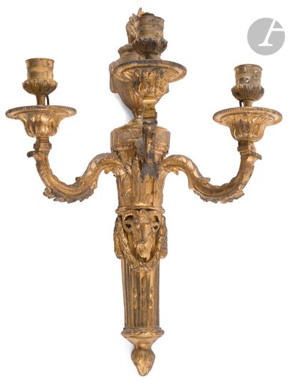 null A pair of ormolu three-light sconces decorated with a vase and a ram's head;...