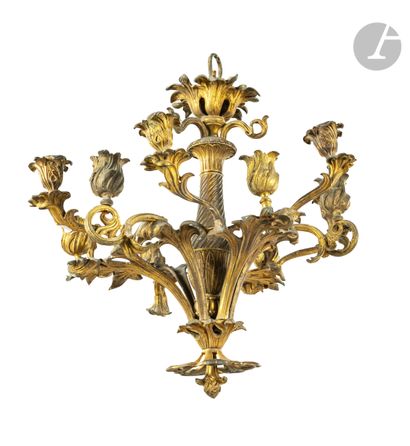 null A gilt bronze chandelier with twelve scrolled lights, decorated with foliage.
Louis...