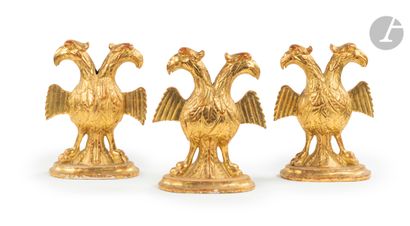 Three double-headed eagles in gilded wood,...
