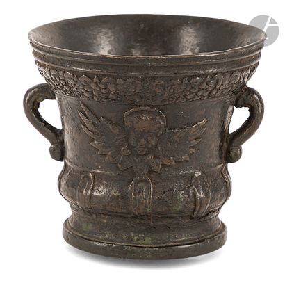 A bronze mortar and pestle set with a cherub's...