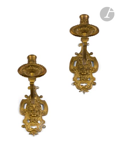  A pair of small ormolu sconces with one arm of light and a mascaron decoration....