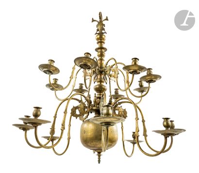  A varnished brass chandelier with sixteen lights on two rows, decorated with mascarons...