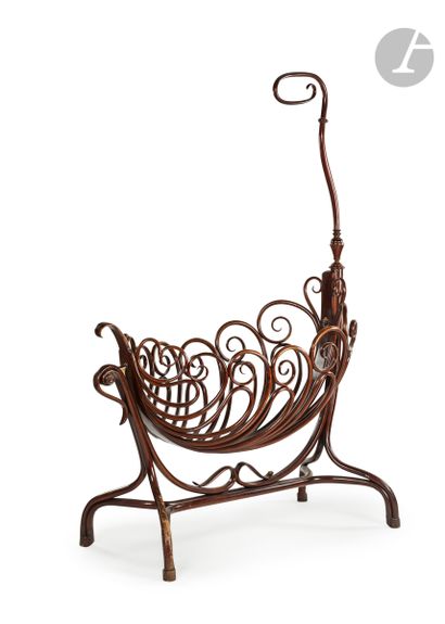 null Large bentwood and stained cradle of shuttle shape, openwork with stylized scrolls...