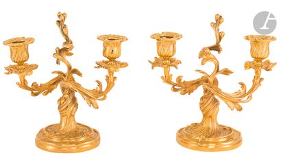 null A pair of small ormolu candelabras with two branches and foliage decoration.
Louis...
