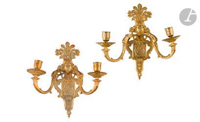 null A pair of two-light ormolu sconces, Diana mask, trophies, palmettes and female...