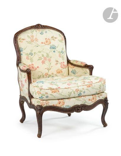 null A large carved and stained beechwood flat back armchair decorated with foliage...
