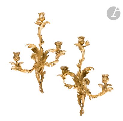  FRAGMENT. A pair of ormolu sconces with three arms of light decorated with foliage...