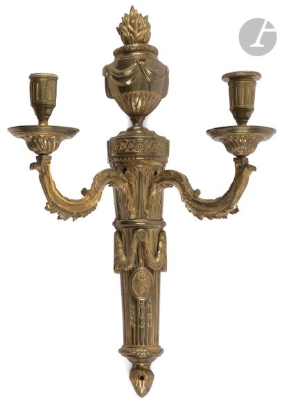 A pair of two-light ormolu sconces decorated...