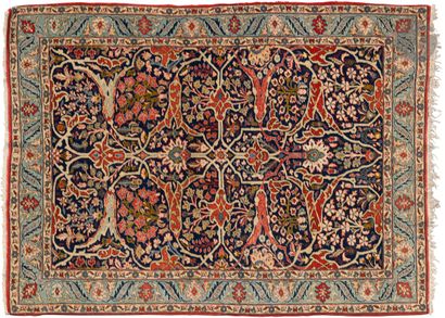  Keshan. Blue background carpet with a large red and ivory floral motif, royal blue...