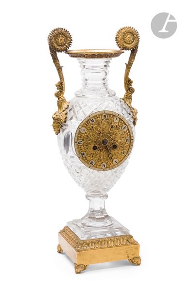  Pendule en verre taillé et bronze doré, le cadran inscrit dans un vase à anses à...