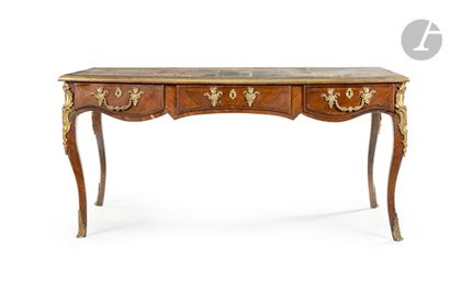 null A rosewood flat desk (replaqué) of a moving form, the belt opening to three...