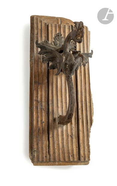 Wrought iron door hammer depicting a winged...