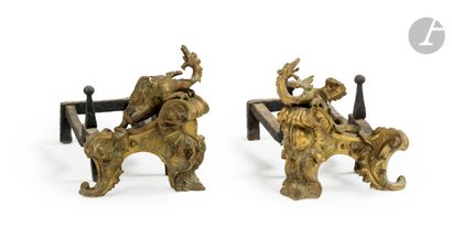 null A pair of ormolu andirons, the base decorated with foliage; with their irons.
Louis...