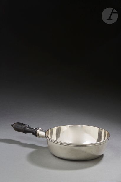 null PARIS 1784
A silver circular saucepan, the handle in turned wood of later period...