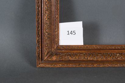 null Carved walnut frame decorated with a frieze of acanthus leaves and a string....