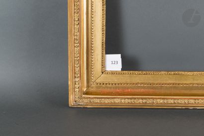null Molded oak frame and gilded stucco decorated with piastres, pearls and rais-de-coeur...