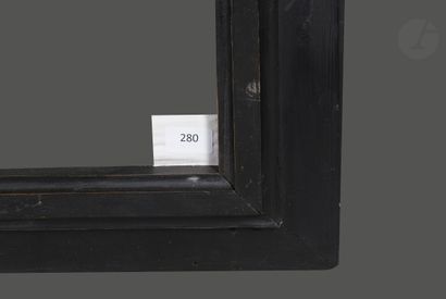 null Large frame with reversed profile in molded and blackened wood.
Beginning of...