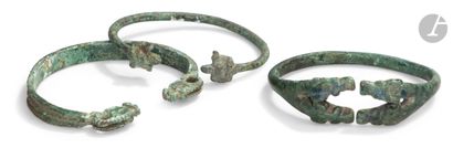 null Set of three open bracelets with ends terminated by animal heads.
Bronze.
Louristan,...