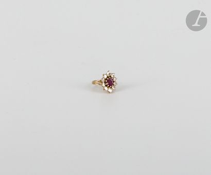 null Ring in 18K (750) gold, set with a round ruby surrounded by round brilliant-cut...