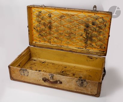 null Travelling case sheathed in yellow leather and brass studs with three side handles,...