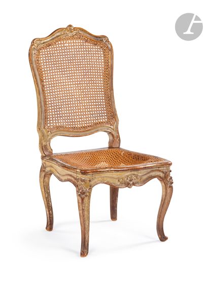 null A molded, carved and painted beechwood cane chair (wear), resting on cambered...