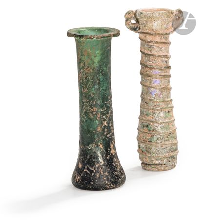 null A green unguentarium and a tubular vase with a net decorated
handleRoman
period
,...