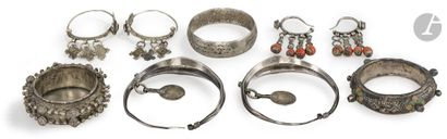 Three pairs of silver earrings and two bracelets,...