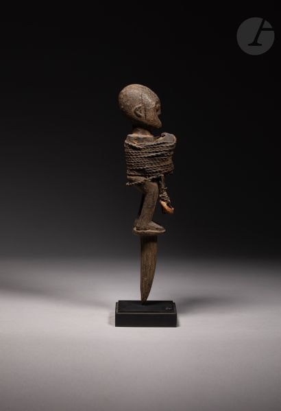 null 
Voodoo stake sculpture decorated with a character sculpted in foot, tied with...