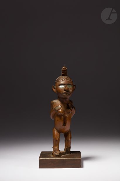 null Ancient female Nkisi statuette with engraved hair in a bun raised on the top...