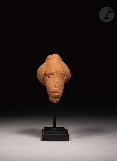 null Elegant head with a bun hairstyle, fragment of an ancient statuette.

Nok culture,...