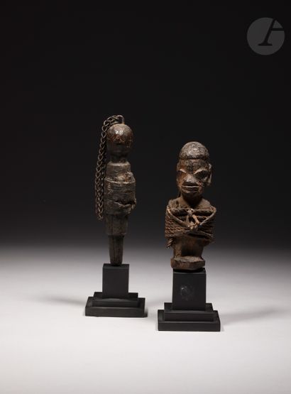 null A lot of two small old voodoo stake sculptures, one of which is in a Nago or...
