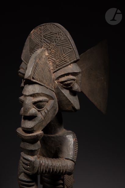 null Ceremonial axe with a three-headed figure wearing bracelets, blowing a flute,...