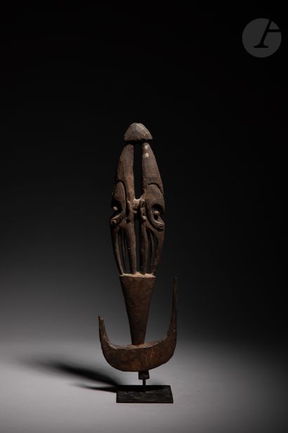 null Ancient sculpture of a suspension hook decorated with two masks back to back.

In...
