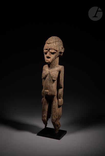 null A very old female Batéba statue, long planted on an altar, with arms along the...
