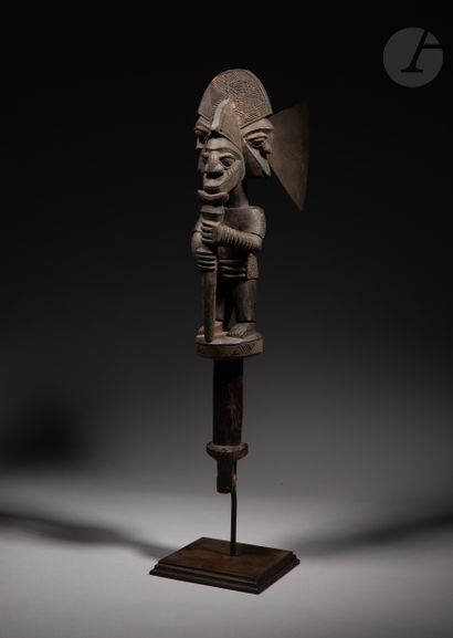 null Ceremonial axe with a three-headed figure wearing bracelets, blowing a flute,...