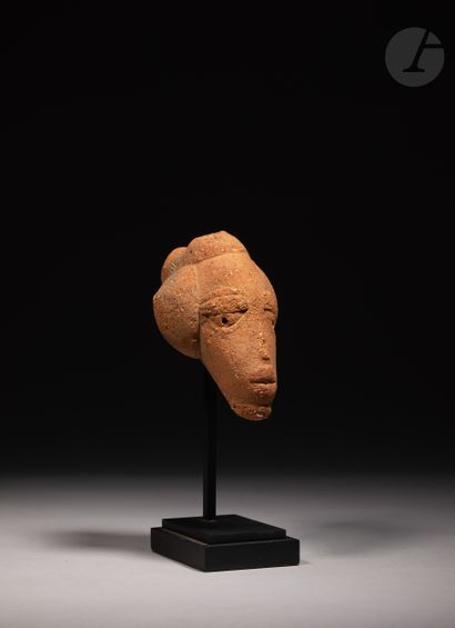 null Elegant head with a bun hairstyle, fragment of an ancient statuette.

Nok culture,...