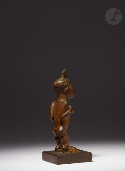 null Ancient female Nkisi statuette with engraved hair in a bun raised on the top...