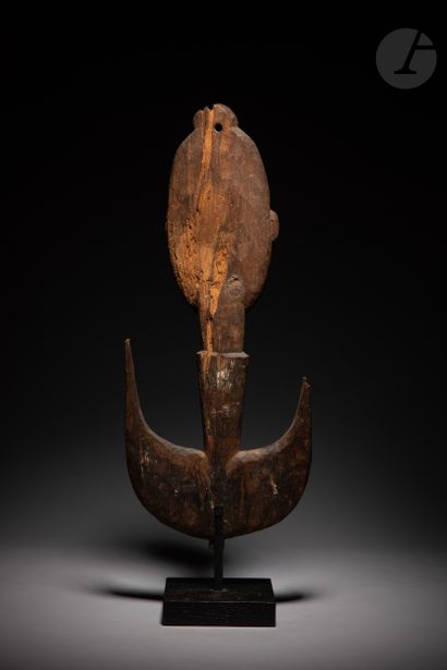null Ancient sculpture of a suspension hook decorated with a large smiling mask,...
