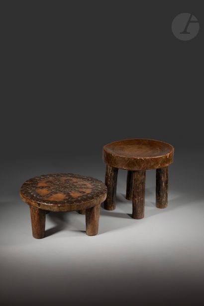 A set of two small circular stools with four...