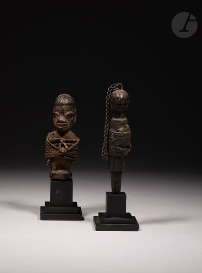 null A lot of two small old voodoo stake sculptures, one of which is in a Nago or...