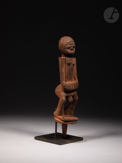 null A group of four voodoo stake statuettes, one of which is a male stake statuette...