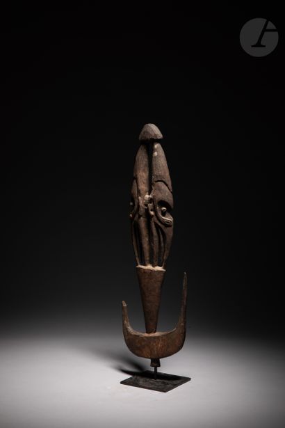 null Ancient sculpture of a suspension hook decorated with two masks back to back.

In...