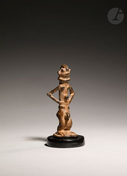null Ancient and rare figurine of a male character with arms on his hips and wearing...