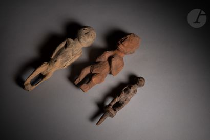 null A group of four voodoo stake statuettes, one of which is a male stake statuette...