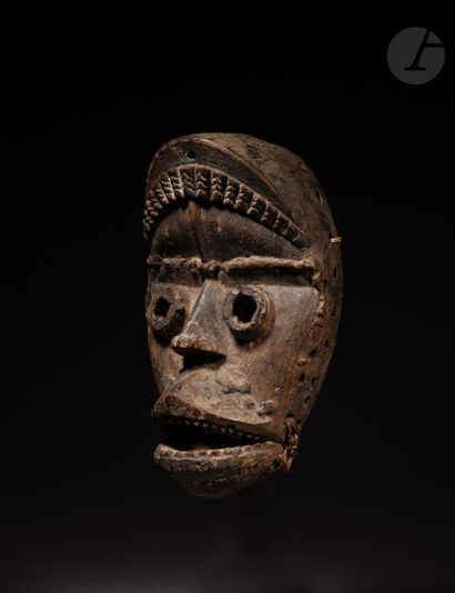 null An ancient and beautiful mask with an articulated jaw, with projected cylindrical...