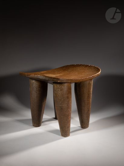 null Superb and ancient monumental kolo stool, the underside of the seat is carved...